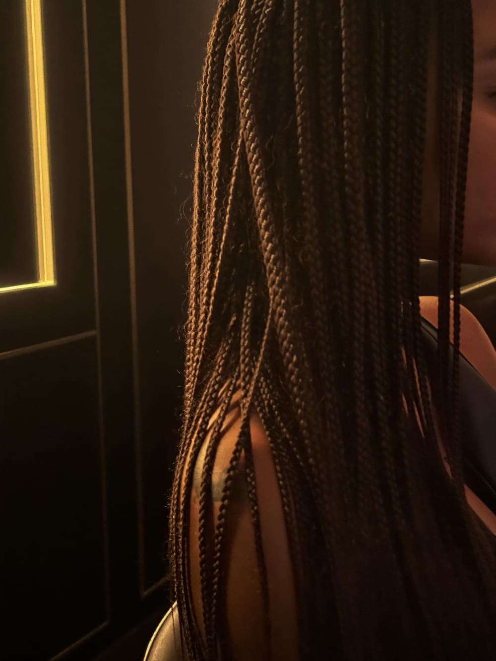 Finished knotless box braids falling past the shoulder
