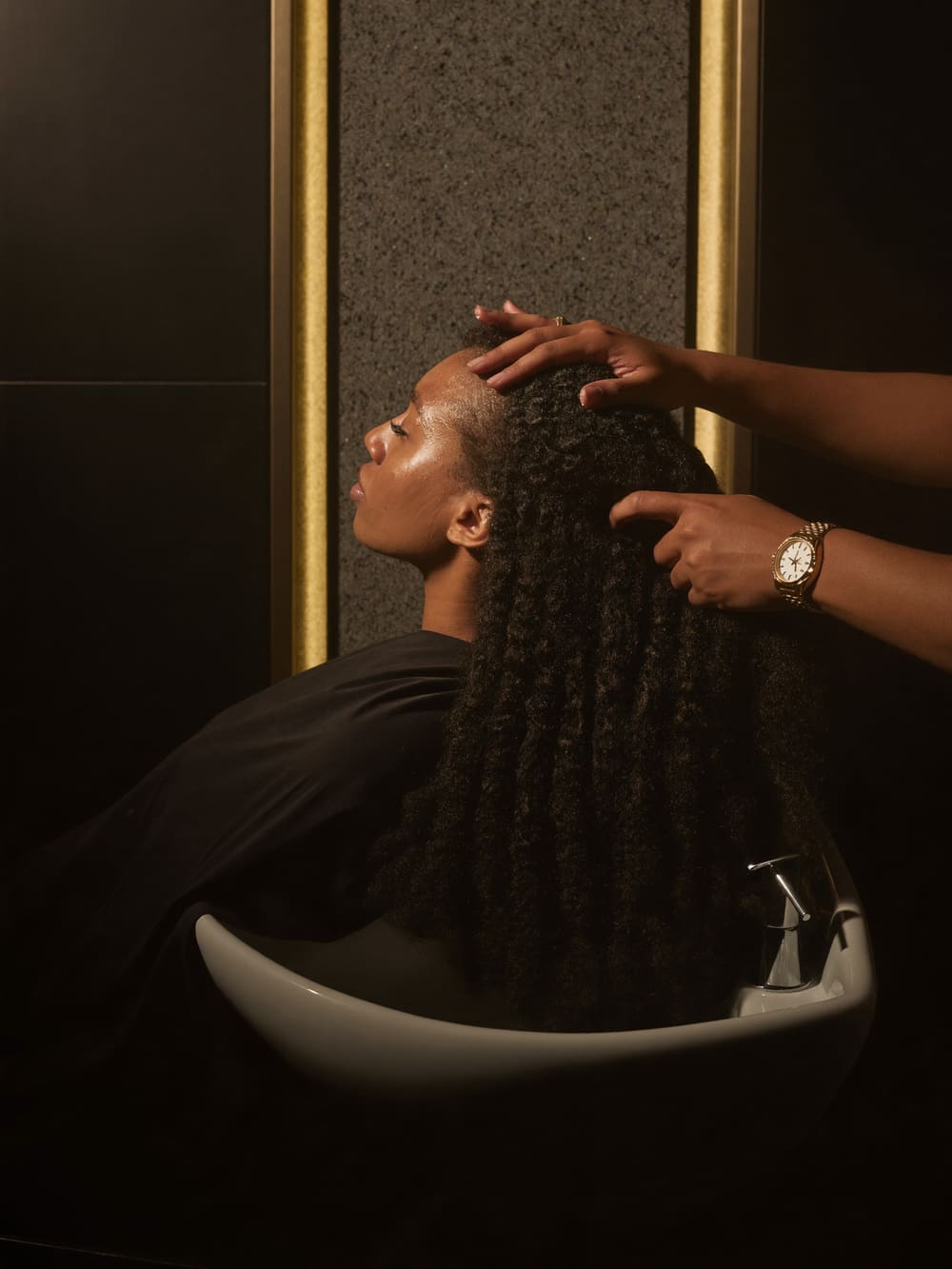 Treatment worked into the scalp at the wash basin